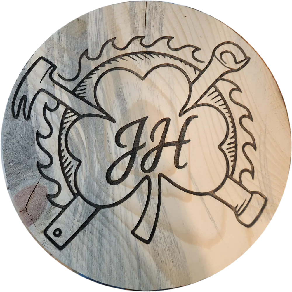 A round pine board wood-burned with a flaming heart, crossed hammer and wrench, and a J J H monogram